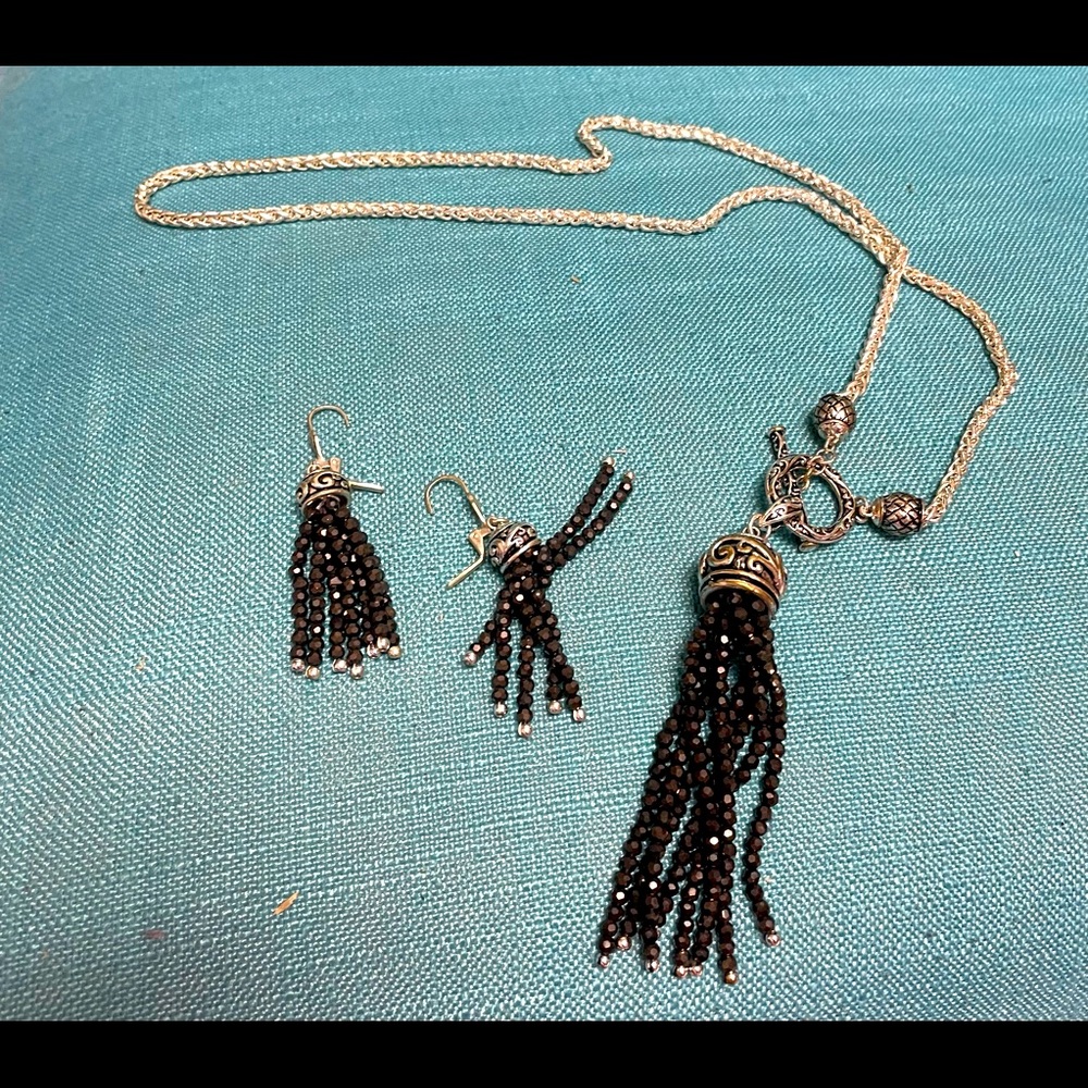 Silver necklace and earrings set with brown bead tassels